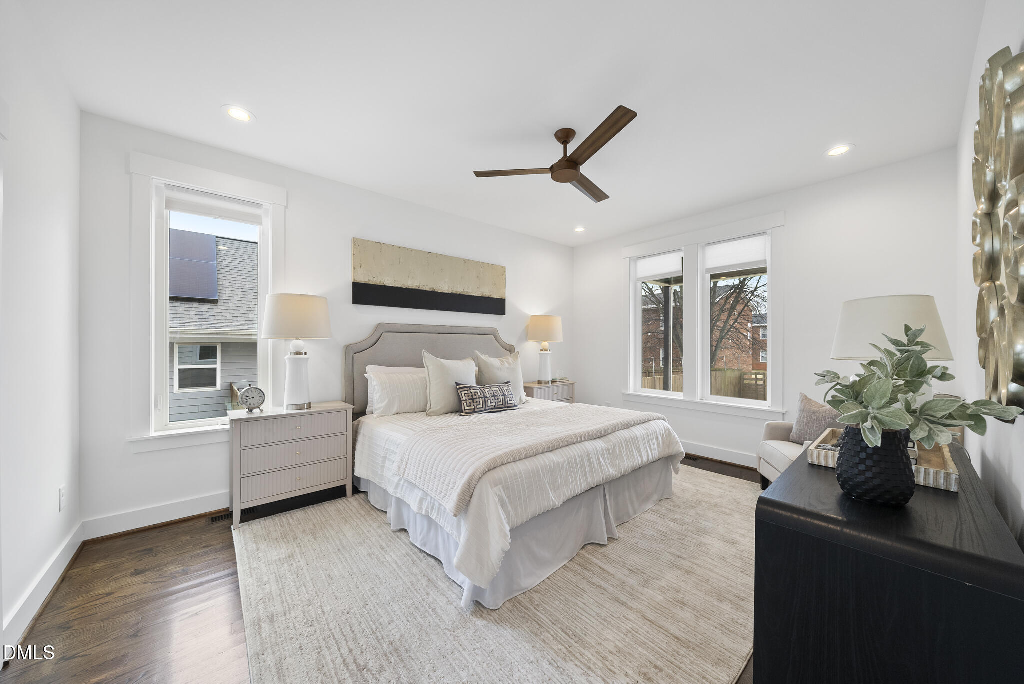 200 Bledsoe Avenue Raleigh, NC 27601 - Photo 16 of 42 a bedroom with a large bed wooden floor and potted plant