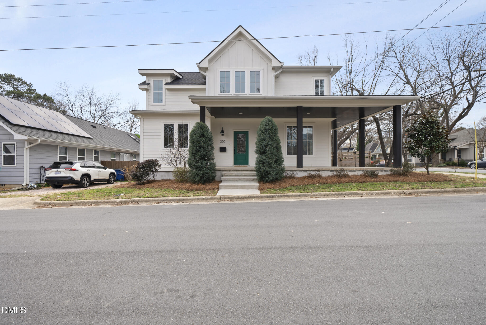 200 Bledsoe Avenue Raleigh, NC 27601 - Photo 2 of 42 a view of a white house with a large windows and a table and chairs