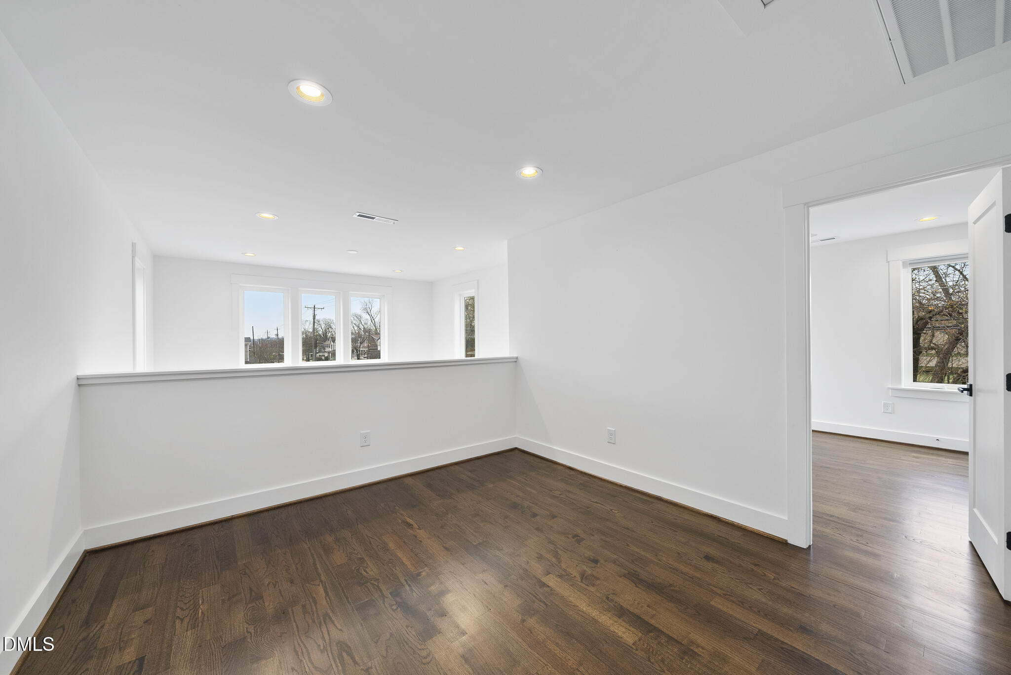 200 Bledsoe Avenue Raleigh, NC 27601 - Photo 25 of 42 a view of an empty room with wooden floor and a window