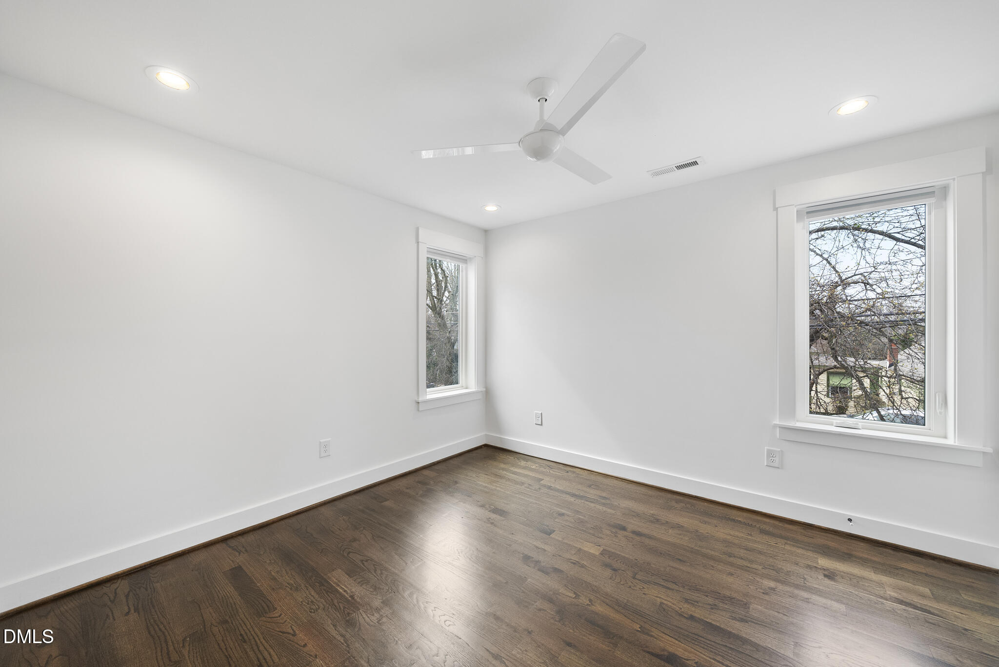 200 Bledsoe Avenue Raleigh, NC 27601 - Photo 29 of 42 an empty room with wooden floor and windows