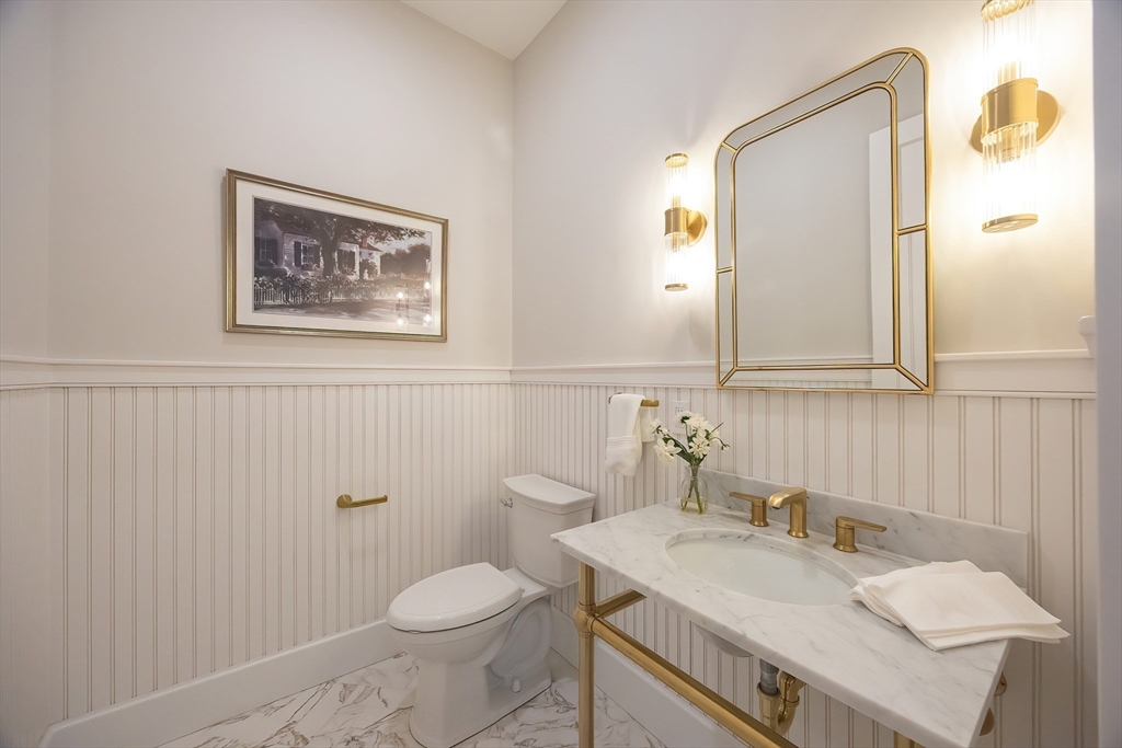 28 Quaker Run Road Mashpee, MA 02649 - Photo 13 of 42 a bathroom with a granite countertop sink mirror vanity and toilet