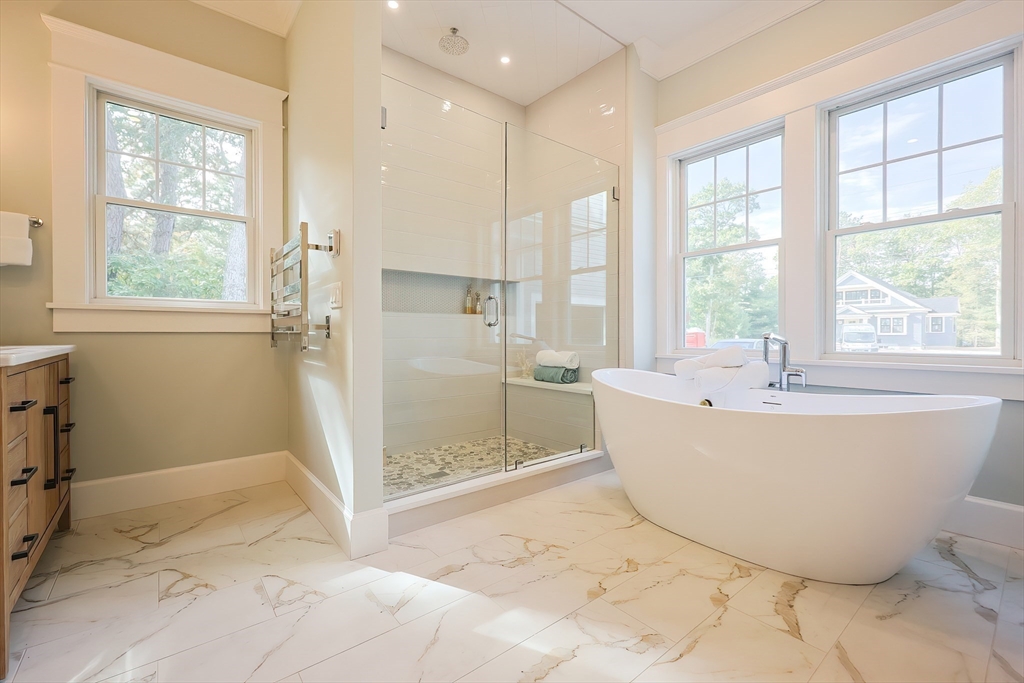 28 Quaker Run Road Mashpee, MA 02649 - Photo 16 of 42 a spacious bathroom with a tub and shower