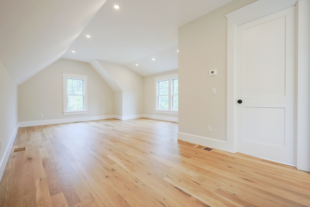 28 Quaker Run Road Mashpee, MA 02649 - Photo 19 of 42 an empty room with wooden floor and windows