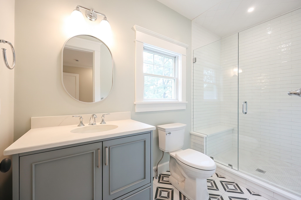 28 Quaker Run Road Mashpee, MA 02649 - Photo 23 of 42 a bathroom with a toilet sink and mirror
