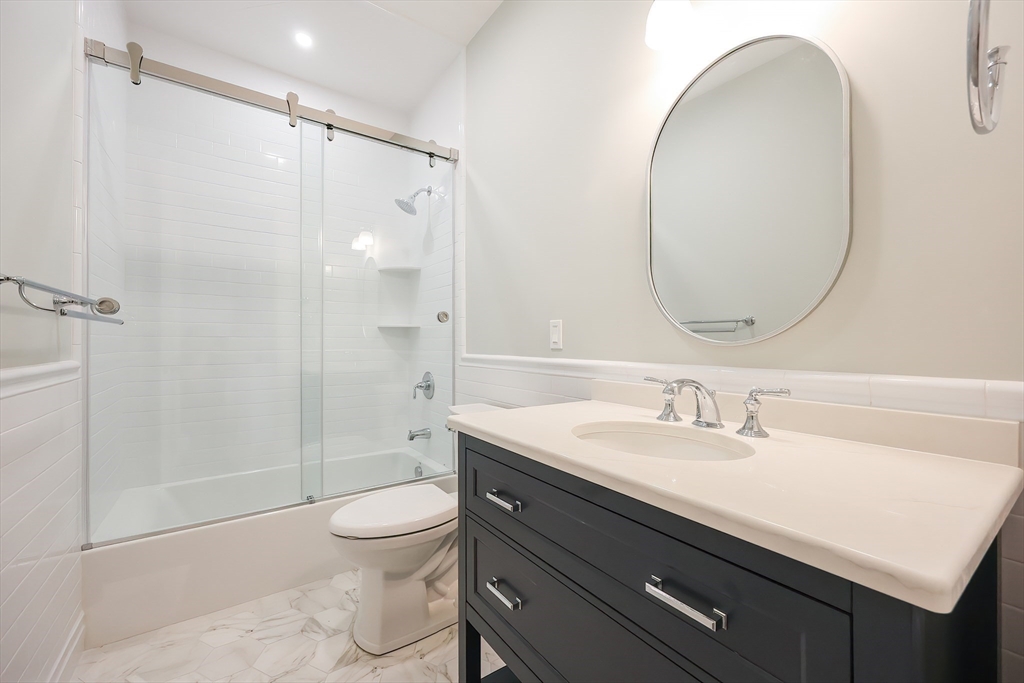 28 Quaker Run Road Mashpee, MA 02649 - Photo 25 of 42 a bathroom with a sink a toilet and a mirror