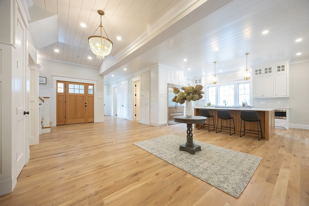 28 Quaker Run Road Mashpee, MA 02649 - Photo 3 of 42 a living room with kitchen island furniture and a chandelier