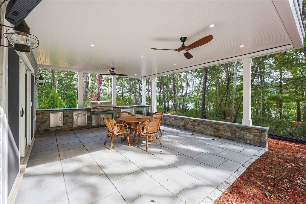 28 Quaker Run Road Mashpee, MA 02649 - Photo 36 of 42 a view of a porch with furniture and a yard