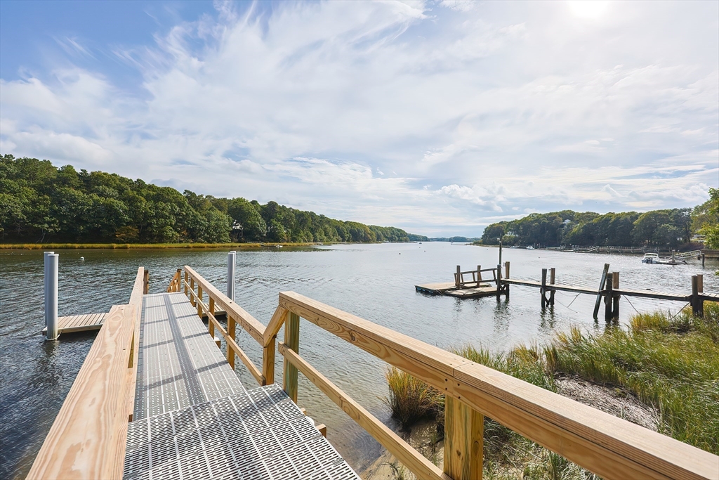 28 Quaker Run Road Mashpee, MA 02649 - Photo 37 of 42 a view of a lake with a deck