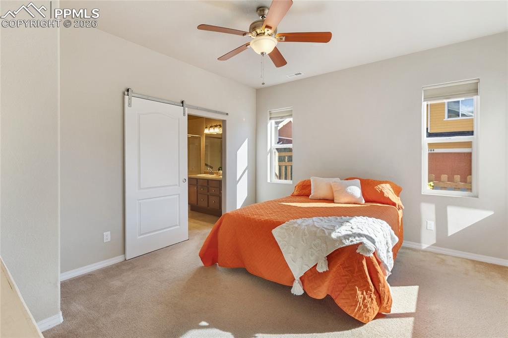 1820 Lower Gold Camp Road Colorado Springs, CO 80905 - Photo 11 of 27 a bedroom with a bed and a chandelier