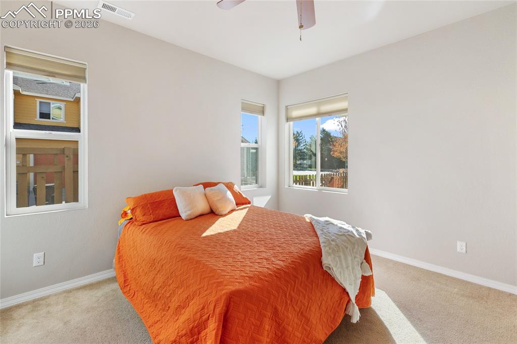1820 Lower Gold Camp Road Colorado Springs, CO 80905 - Photo 12 of 27 a bed sitting in a bedroom next to a window
