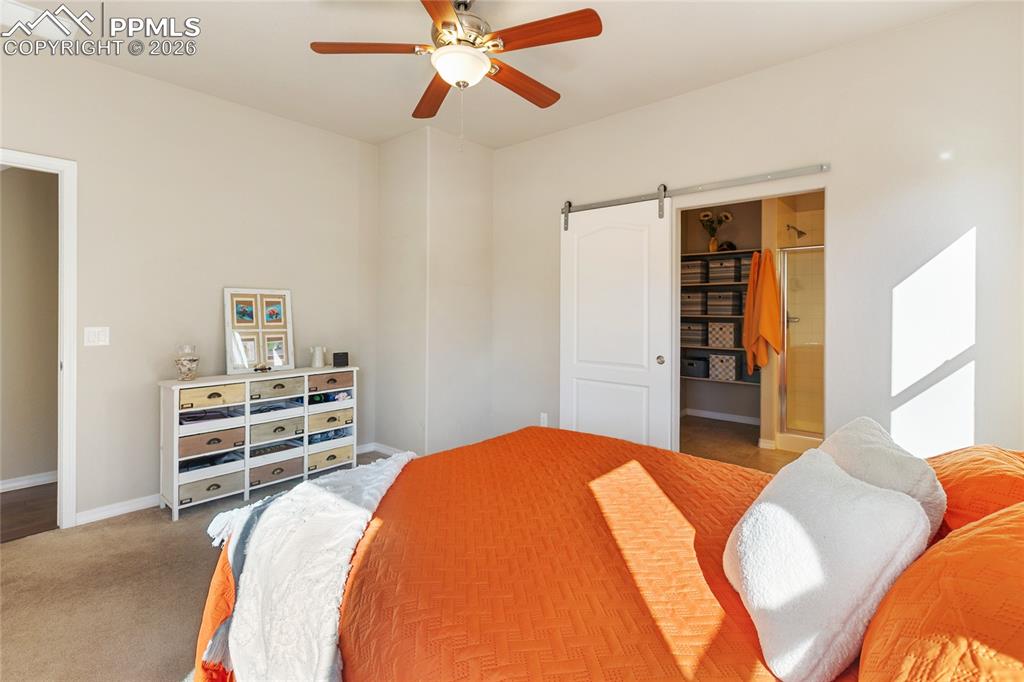 1820 Lower Gold Camp Road Colorado Springs, CO 80905 - Photo 13 of 27 a bedroom with a bed and a chandelier