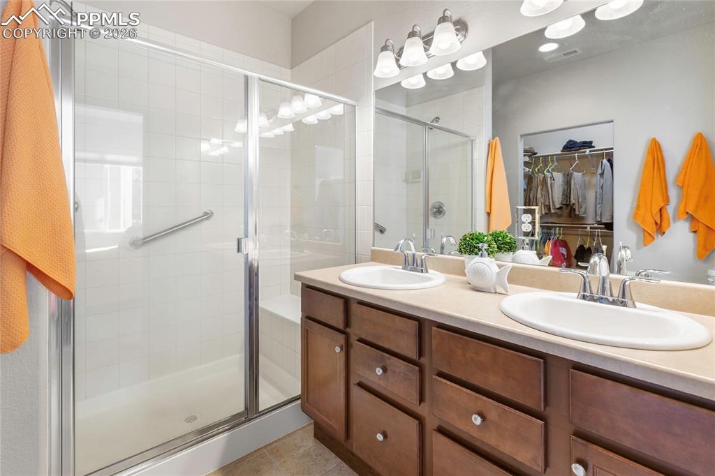 1820 Lower Gold Camp Road Colorado Springs, CO 80905 - Photo 15 of 27 a bathroom with a double vanity sink mirror and shower