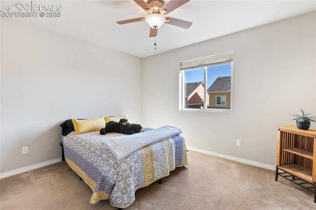 1820 Lower Gold Camp Road Colorado Springs, CO 80905 - Photo 18 of 27 a bedroom with a bed and a chandelier