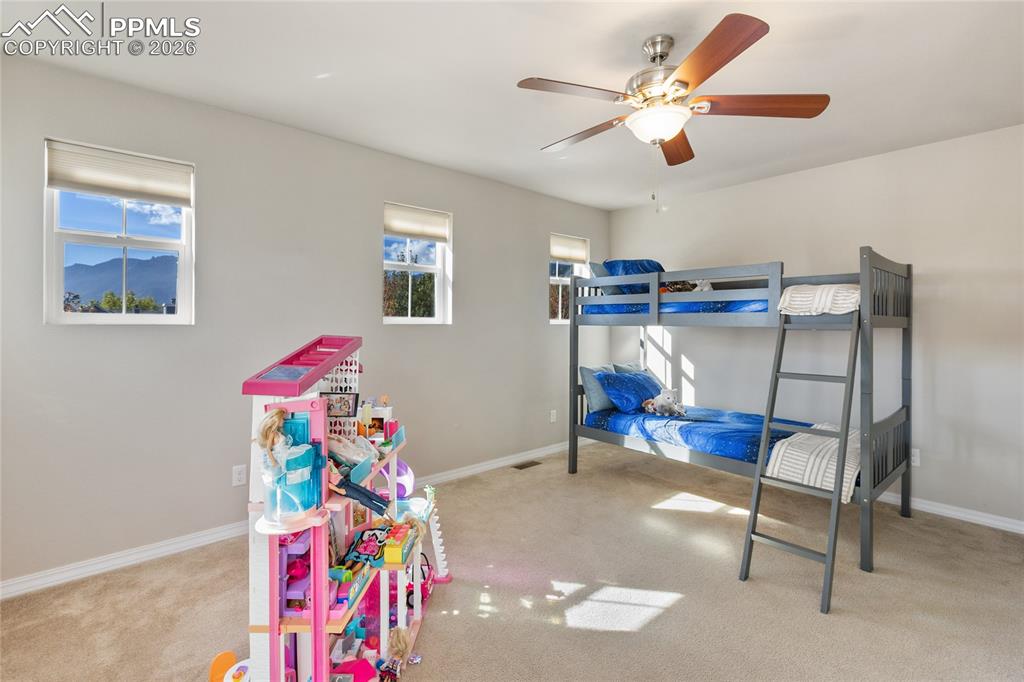 1820 Lower Gold Camp Road Colorado Springs, CO 80905 - Photo 22 of 27 a view of play room with furniture and ceiling fan