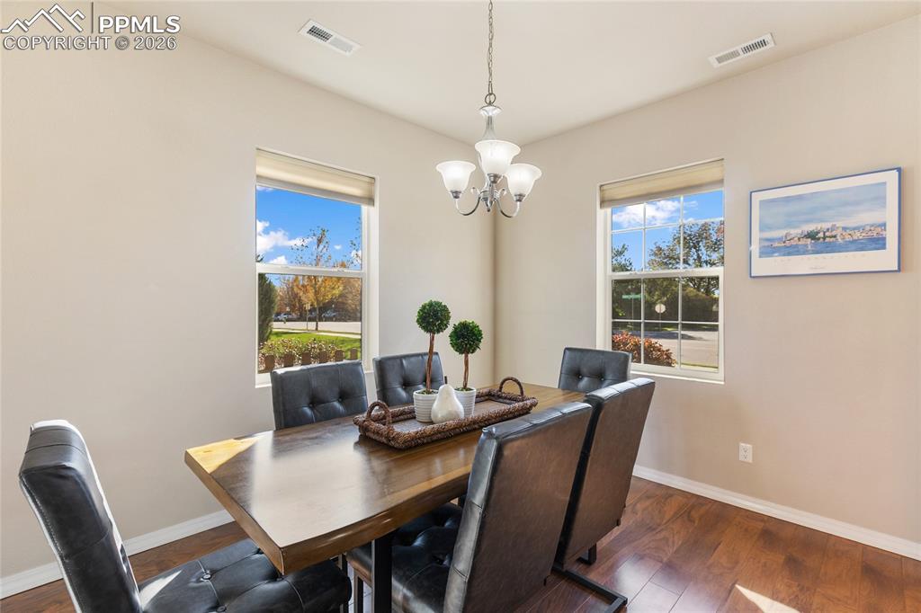 1820 Lower Gold Camp Road Colorado Springs, CO 80905 - Photo 7 of 27 a view of a dining room with furniture window and wooden floor