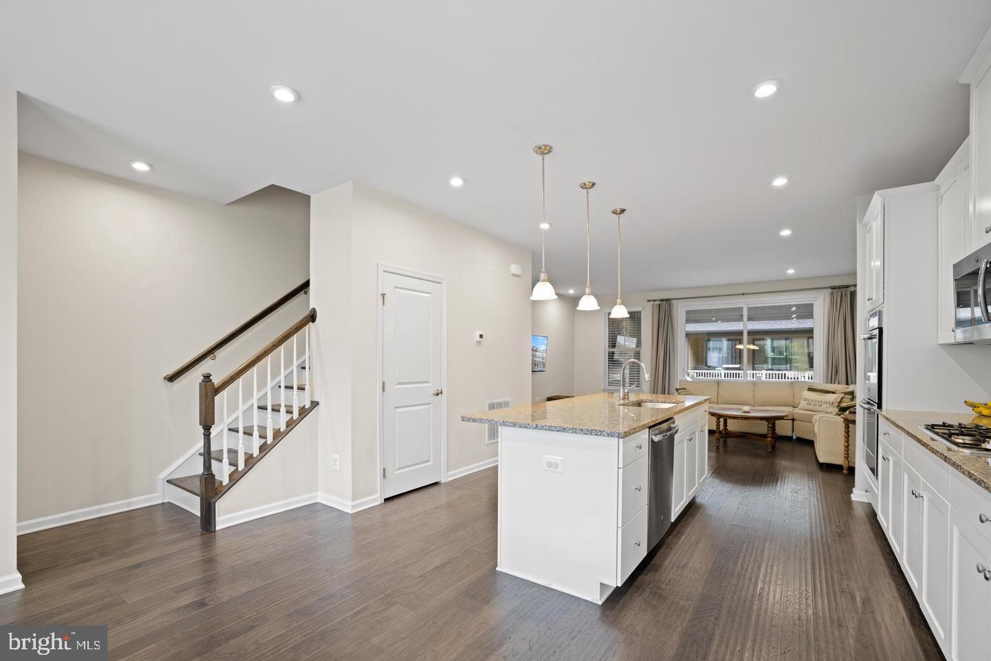 22255 Sims Terrace Ashburn, VA 20148 - Photo 17 of 27 a large white kitchen with a large counter top appliances and cabinets