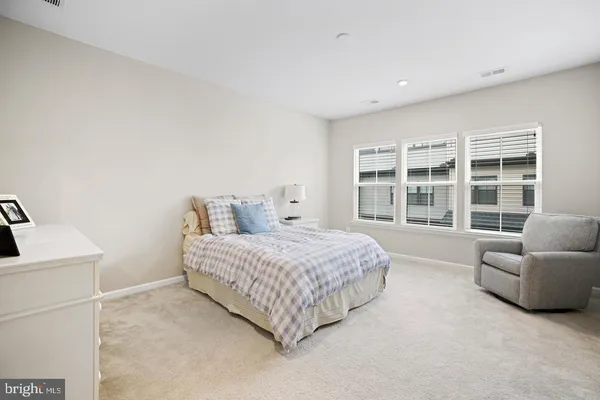 a spacious bedroom with a bed and a couch