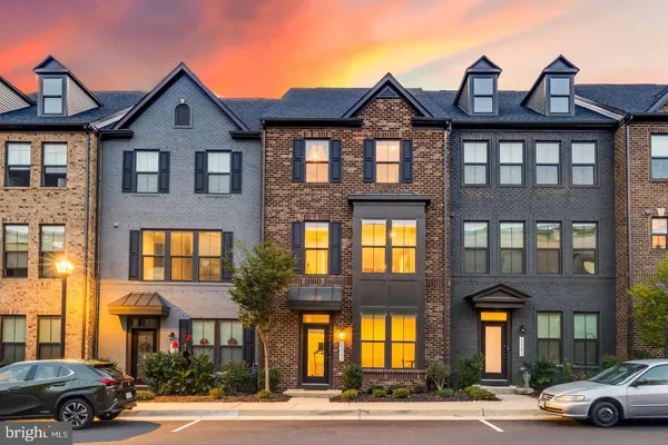 a front view of a residential apartment building with a yard