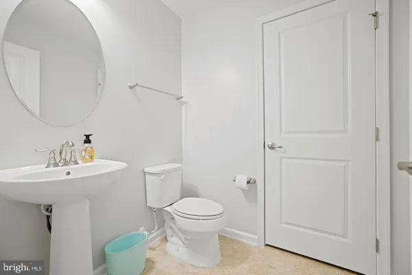 a bathroom with a toilet a sink and a mirror