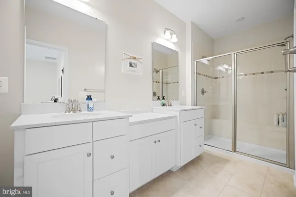 a bathroom with double sink and mirror