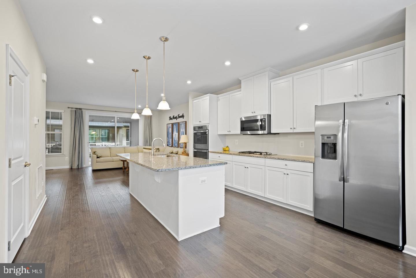 22255 Sims Terrace Ashburn, VA 20148 - Photo 23 of 27 a kitchen with counter top space a sink cabinets and stainless steel appliances