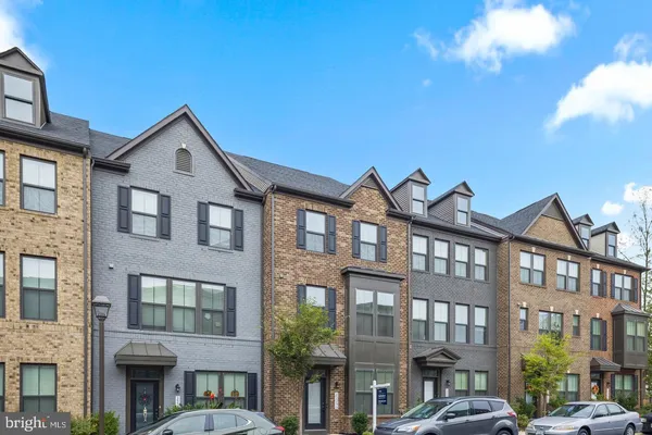 a front view of a residential apartment building with a yard