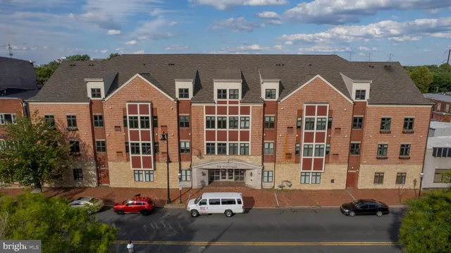 a front view of a residential apartment building with a yard
