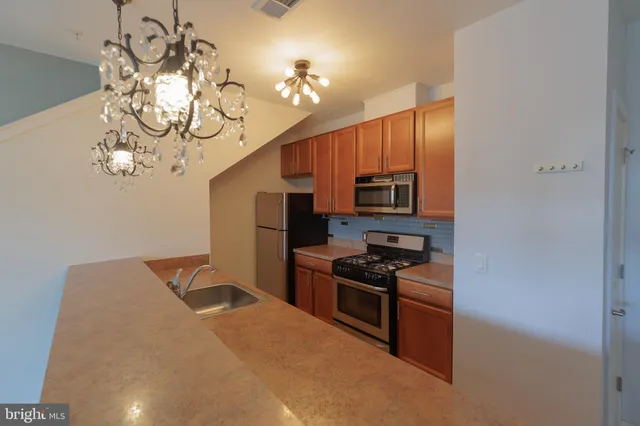 a kitchen with sink cabinets and stainless steel appliances