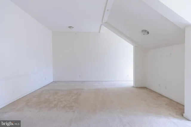 an empty room with closet and a bathroom