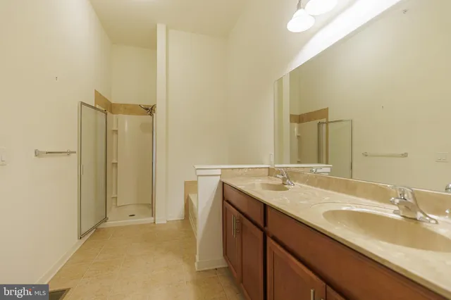 a bathroom with a sink and granite countertop a mirror