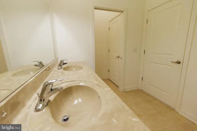 a bathroom with a bathtub sink mirror vanity and toilet
