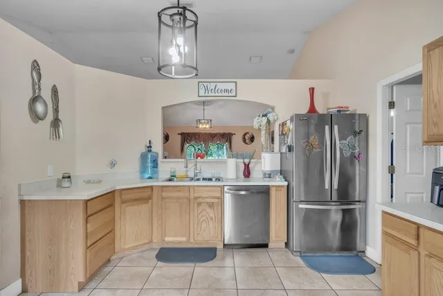 a kitchen with stainless steel appliances granite countertop a refrigerator and a stove top oven