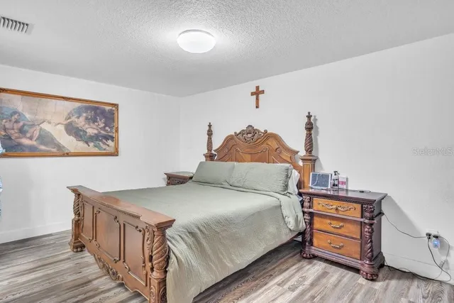 a bed room with a bed and a dresser