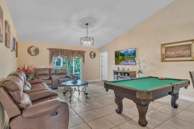 a open kitchen with stainless steel appliances granite countertop a refrigerator and a stove top oven