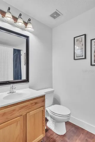a white toilet sitting next to a shower curtain