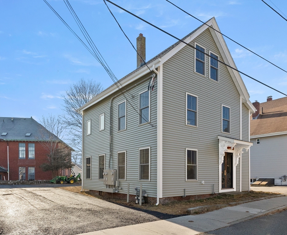 20 Beacon Street Gloucester, MA 01930 - Photo 1 of 35 a front view of a house with a yard