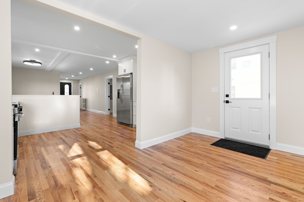 20 Beacon Street Gloucester, MA 01930 - Photo 11 of 35 a view of a big room with wooden floor and windows