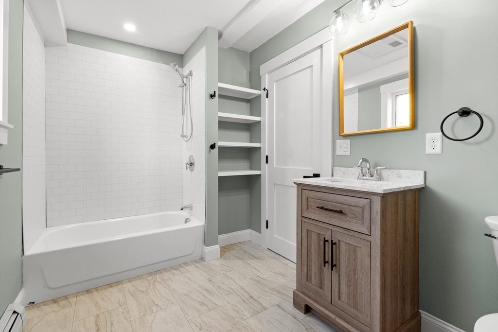 20 Beacon Street Gloucester, MA 01930 - Photo 12 of 35 a bathroom with a tub sink and mirror