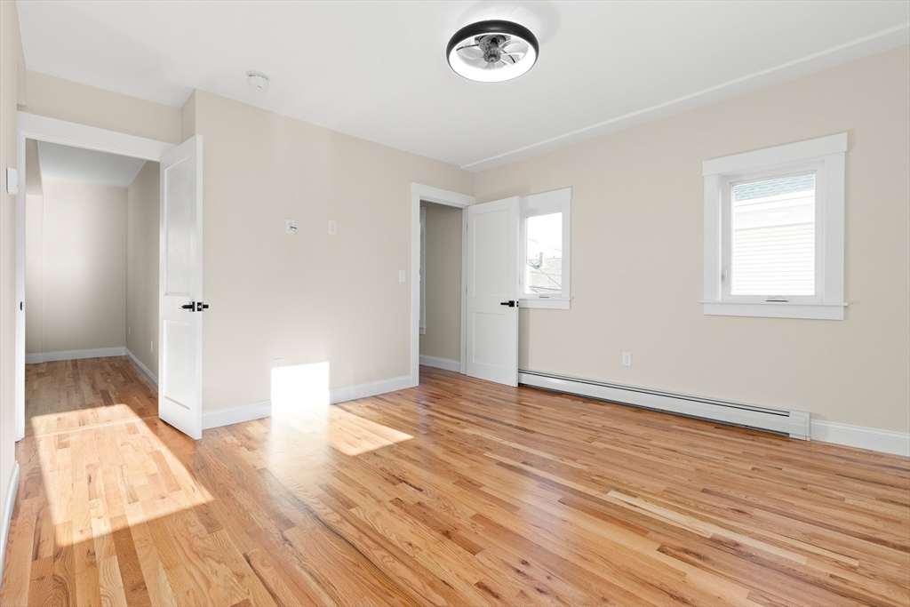 20 Beacon Street Gloucester, MA 01930 - Photo 21 of 35 an empty room with wooden floor and windows