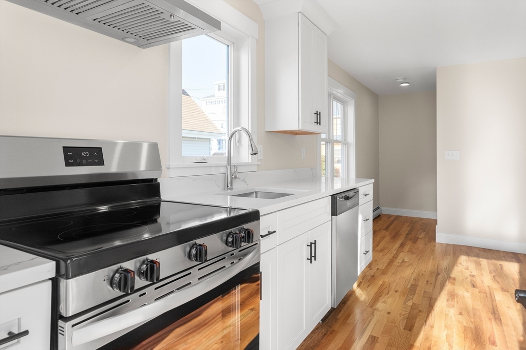 20 Beacon Street Gloucester, MA 01930 - Photo 23 of 35 a kitchen with stainless steel appliances granite countertop a stove and a sink