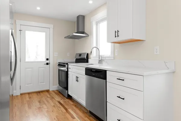 a kitchen with a refrigerator and a window