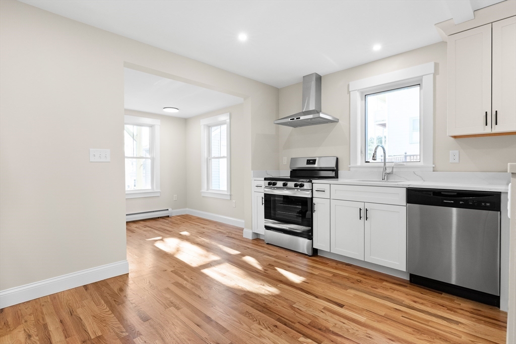 20 Beacon Street Gloucester, MA 01930 - Photo 6 of 35 a kitchen with stainless steel appliances granite countertop a stove a sink and a microwave