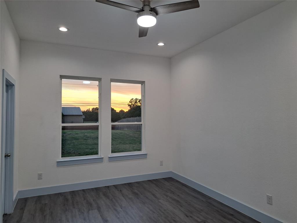 3235 Noor Street Dallas, TX 75233 - Photo 13 of 19 an empty room with wooden floor and windows