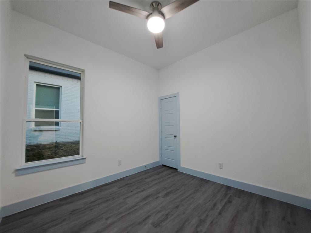 3235 Noor Street Dallas, TX 75233 - Photo 17 of 19 a view of an empty room with wooden floor and a window
