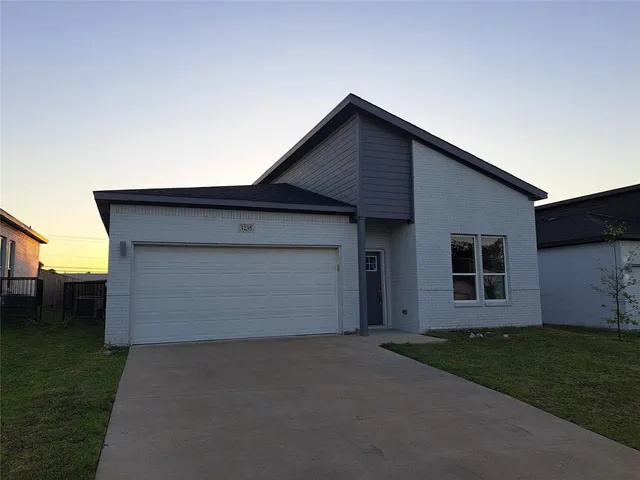 a front view of house with garage and yard