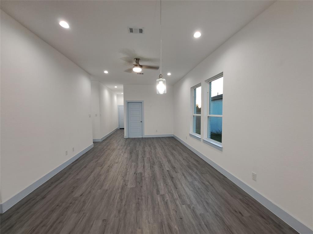 3235 Noor Street Dallas, TX 75233 - Photo 8 of 19 an empty room with wooden floor and windows