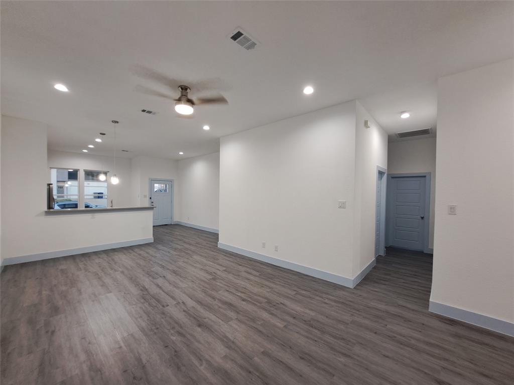 3235 Noor Street Dallas, TX 75233 - Photo 9 of 19 wooden floor in an empty room with a kitchen