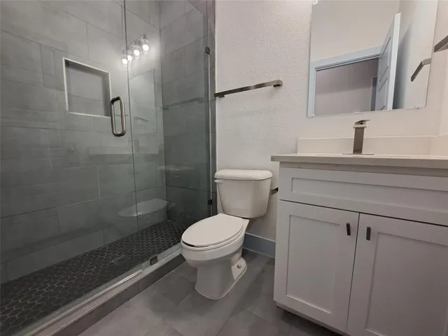 a bathroom with a toilet sink and shower