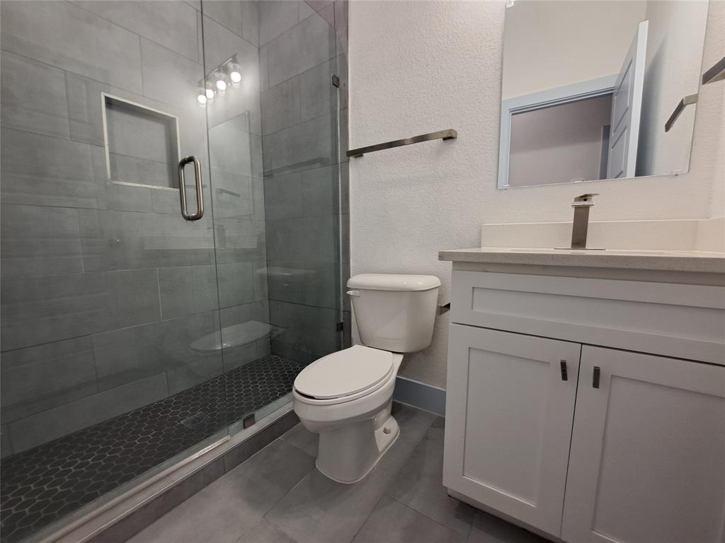 3235 Noor Street Dallas, TX 75233 - Photo 10 of 19 a bathroom with a toilet sink and shower