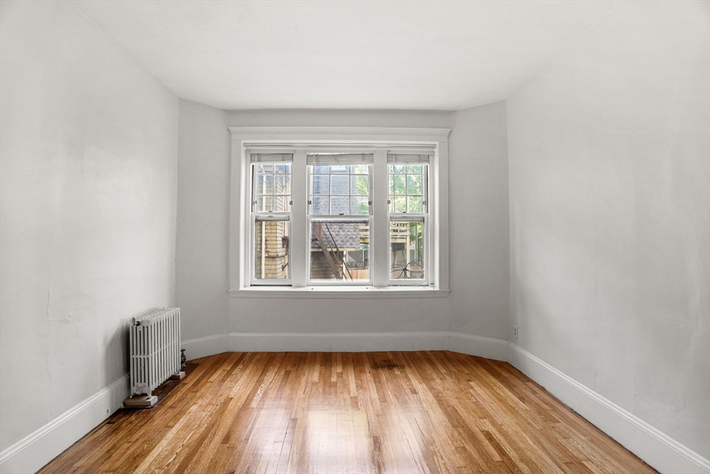 30 Kilsyth Road, Unit 3 Brookline, MA 02445 - Photo 2 of 11 an empty room with wooden floor and windows